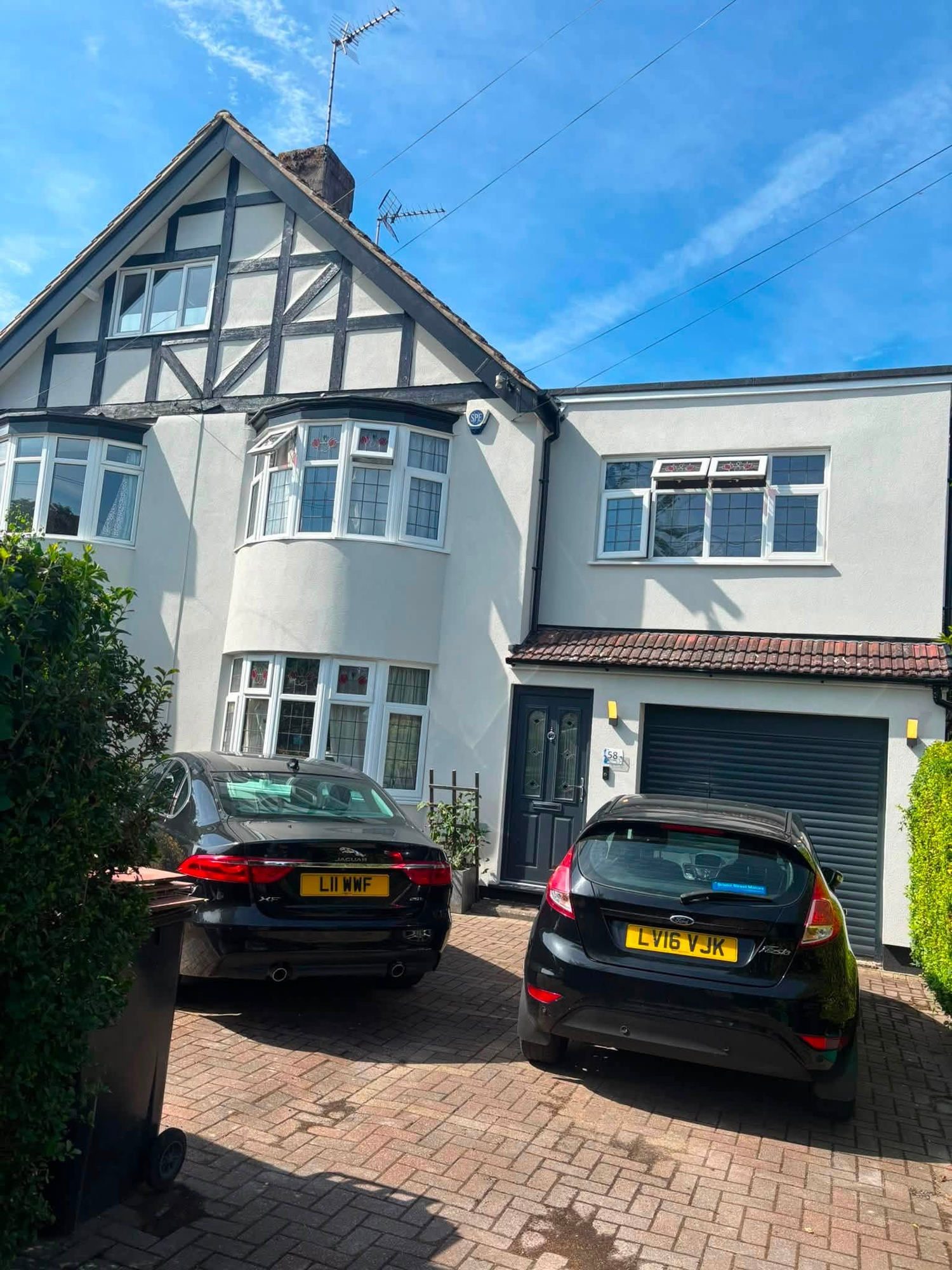Rendered semi-detached house with a mock Tudor gable and a block paved driveway