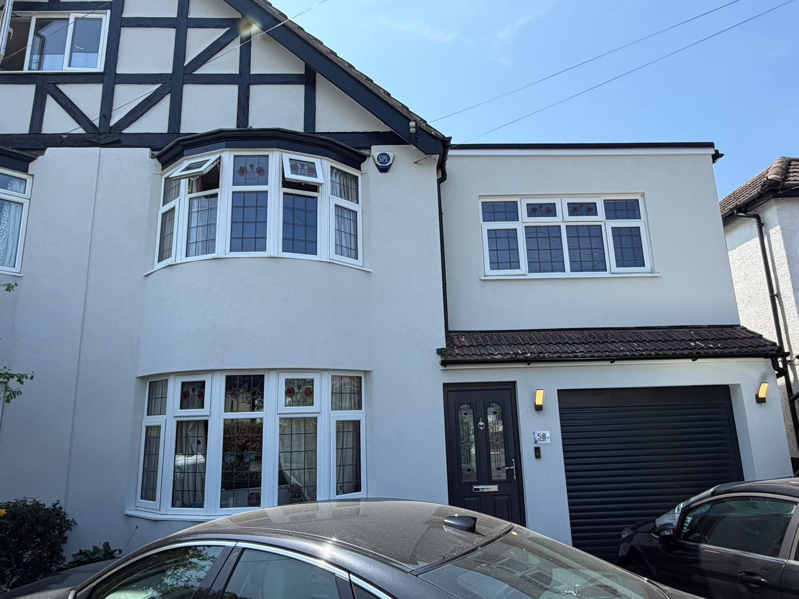 Rendered gable, bay window and garage finished in white silicone render