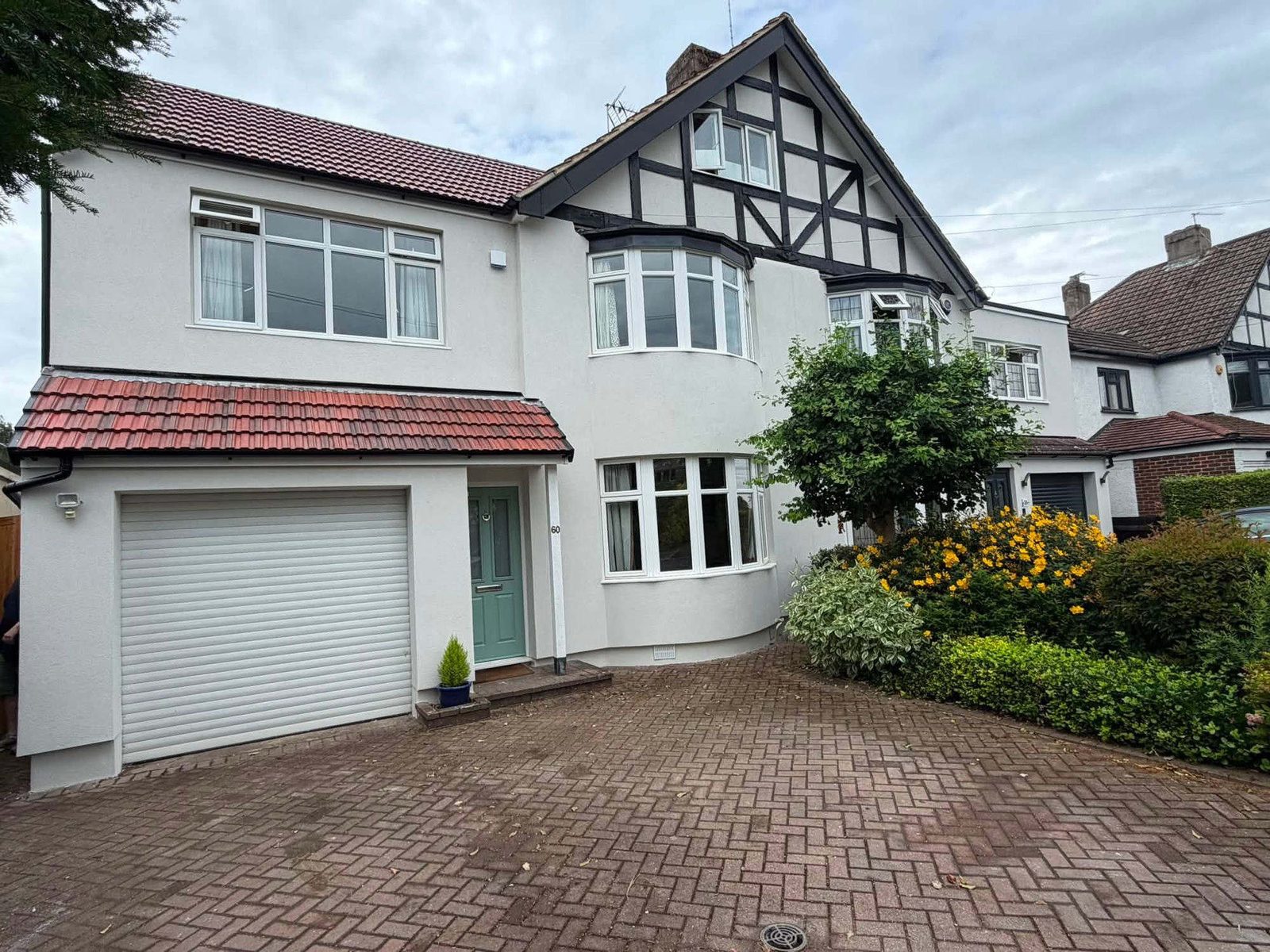 The same house finished in white silicone render with the scaffold down