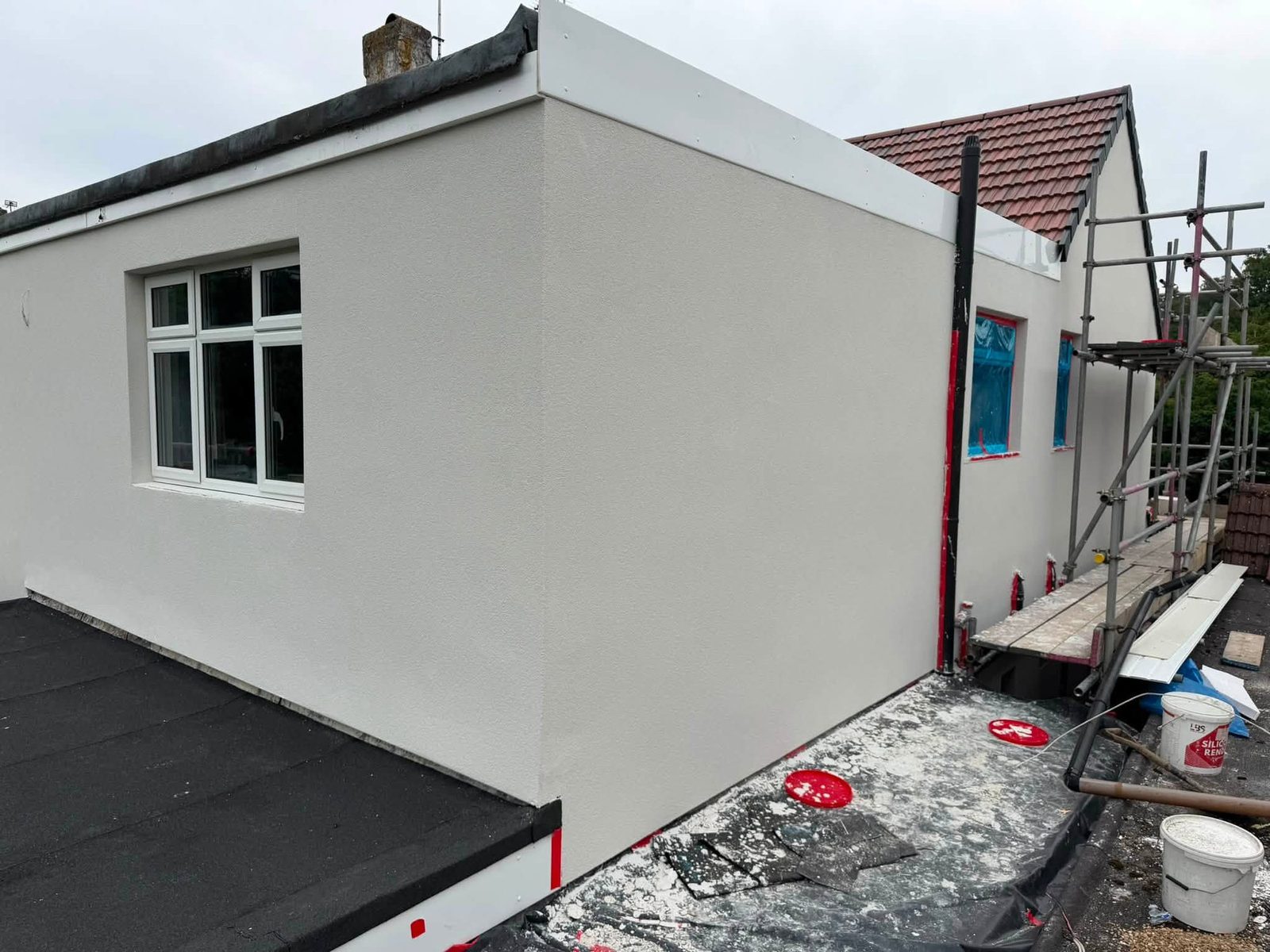 Newly applied silicone render on a flat roof extension with beads still visible